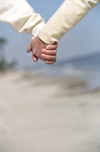 Senior Couple Holding Hands at Beach